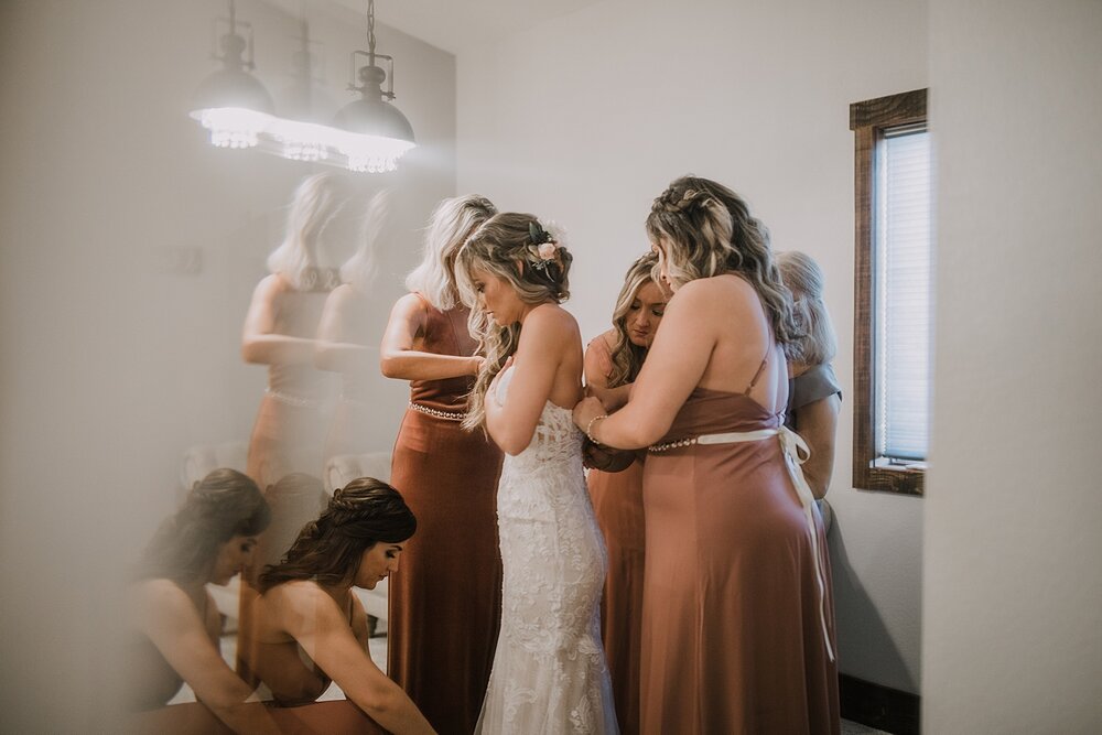 bride putting on dress, the barn at sunset ranch in buena vista co, buena vista colorado wedding, the barn at sunset ranch wedding, buena vista colorado wedding venue