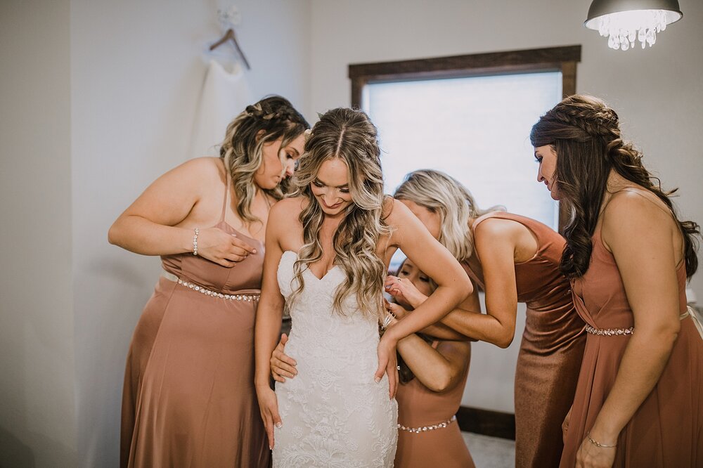 bride putting on dress, the barn at sunset ranch in buena vista co, buena vista colorado wedding, the barn at sunset ranch wedding, buena vista colorado wedding venue