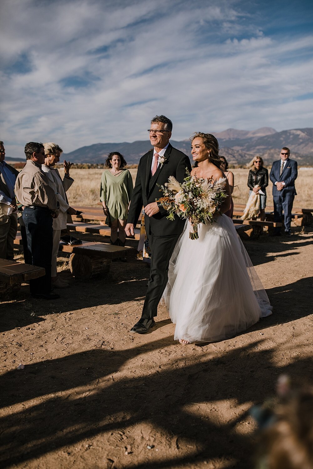 bride walking down the aisle, grooms first look, the barn at sunset ranch in buena vista co, buena vista colorado wedding, the barn at sunset ranch wedding, buena vista colorado wedding venue