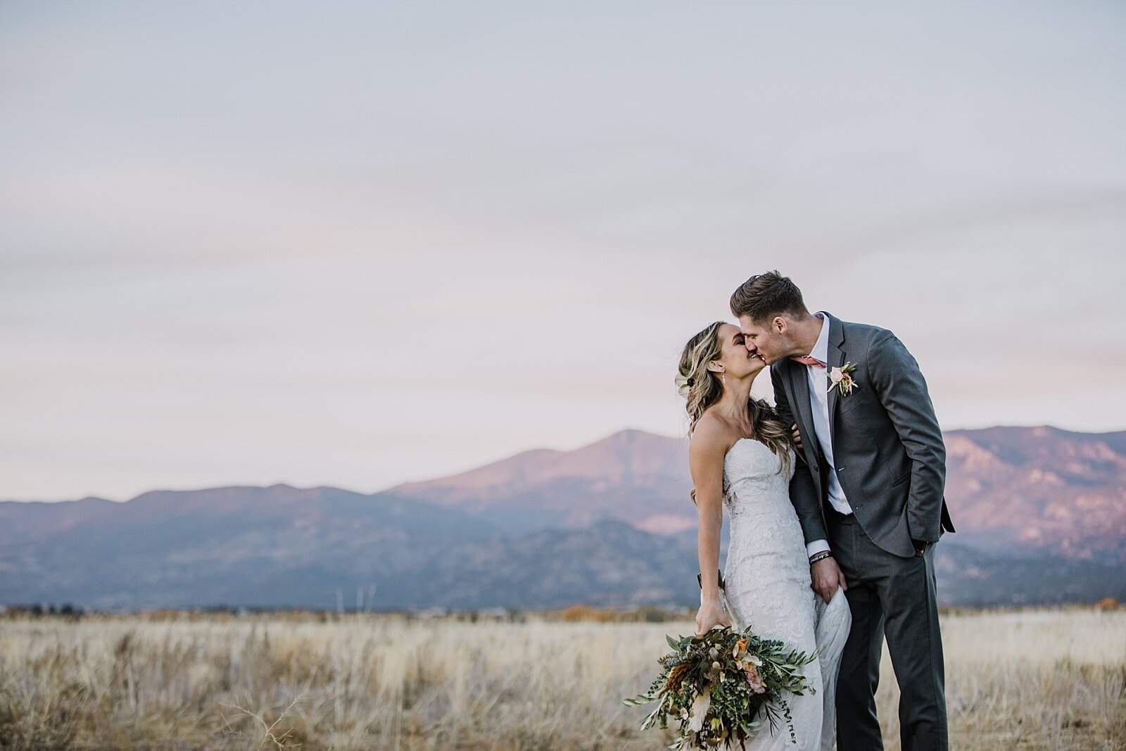 bride and groom kissing, alpine glow on mt princeton, the barn at sunset ranch in buena vista co, buena vista colorado wedding, the barn at sunset ranch wedding, buena vista colorado wedding venue
