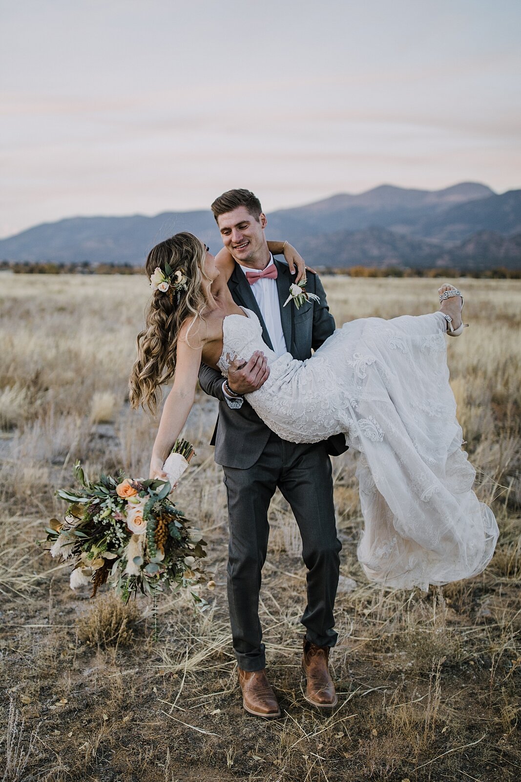 groom carrying bride, alpine glow on mt princeton, the barn at sunset ranch in buena vista co, buena vista colorado wedding, the barn at sunset ranch wedding, buena vista colorado wedding venue