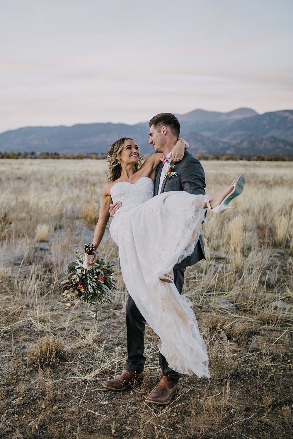 groom carrying bride, alpine glow on mt princeton, the barn at sunset ranch in buena vista co, buena vista colorado wedding, the barn at sunset ranch wedding, buena vista colorado wedding venue