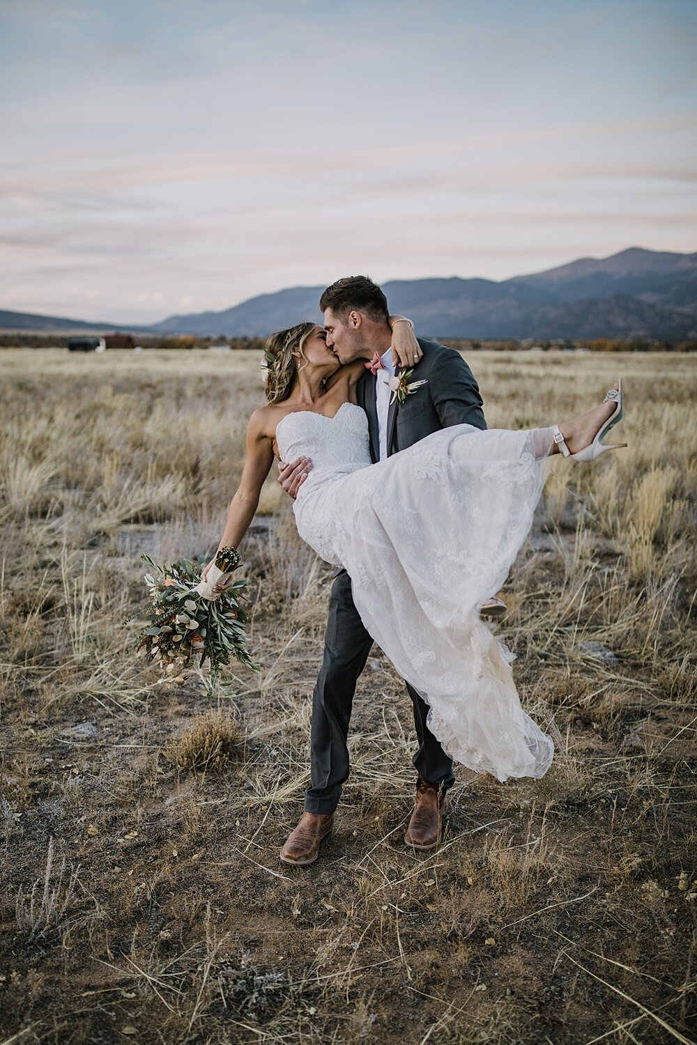 groom carrying bride, alpine glow on mt princeton, the barn at sunset ranch in buena vista co, buena vista colorado wedding, the barn at sunset ranch wedding, buena vista colorado wedding venue