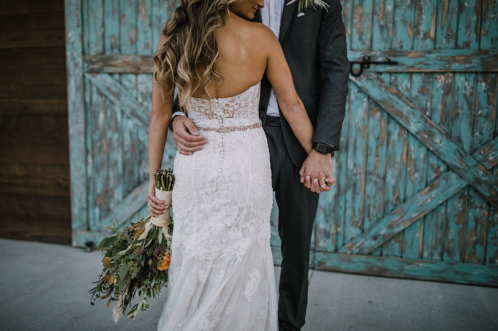 bride and groom in front of barn doors, the barn at sunset ranch in buena vista co, buena vista colorado wedding, the barn at sunset ranch wedding, buena vista colorado wood barn wedding venue