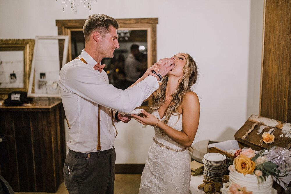 cutting the cake, smashing the cake, the barn at sunset ranch in buena vista co, buena vista colorado wedding, the barn at sunset ranch wedding, buena vista colorado wedding venue