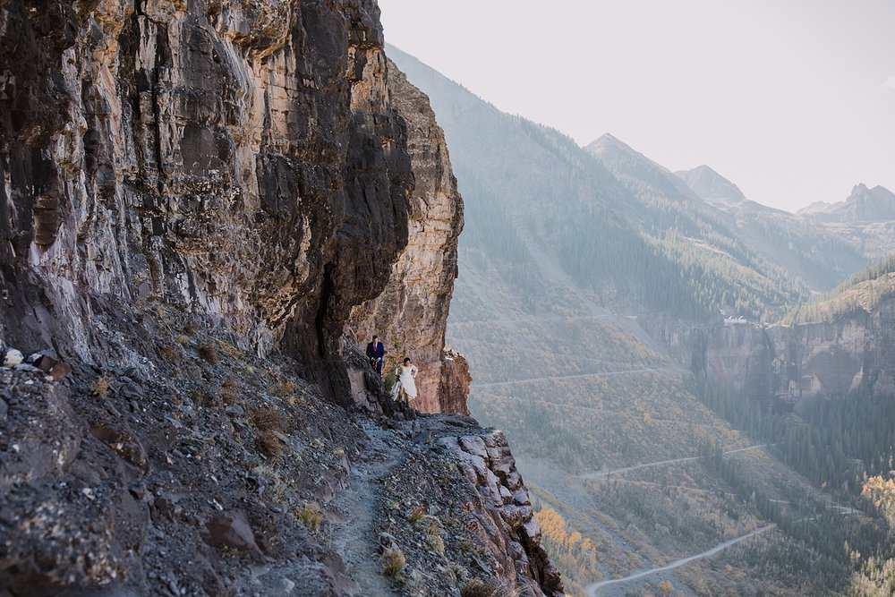 bride and groom hiking after climbing past the crux, climbing through telluride's via ferrata main event, climbing elopement in the san juan mountain range of colorado