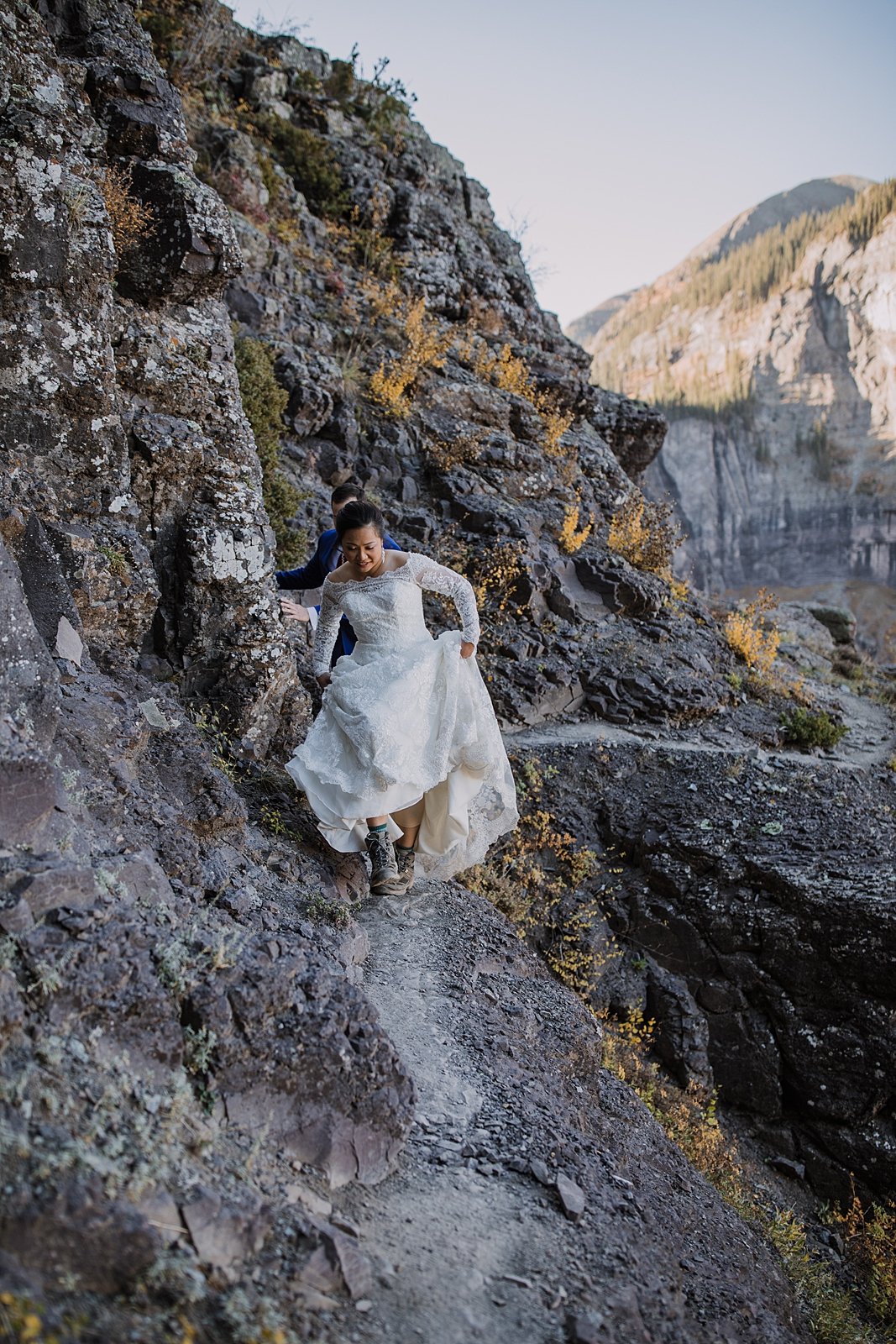 telluride via ferrata in a wedding dress, bride and groom eloping on a cliff edge, high alpine mountaineering elopement, high alpine elopement, southern colorado hiking elopement, climbing couple
