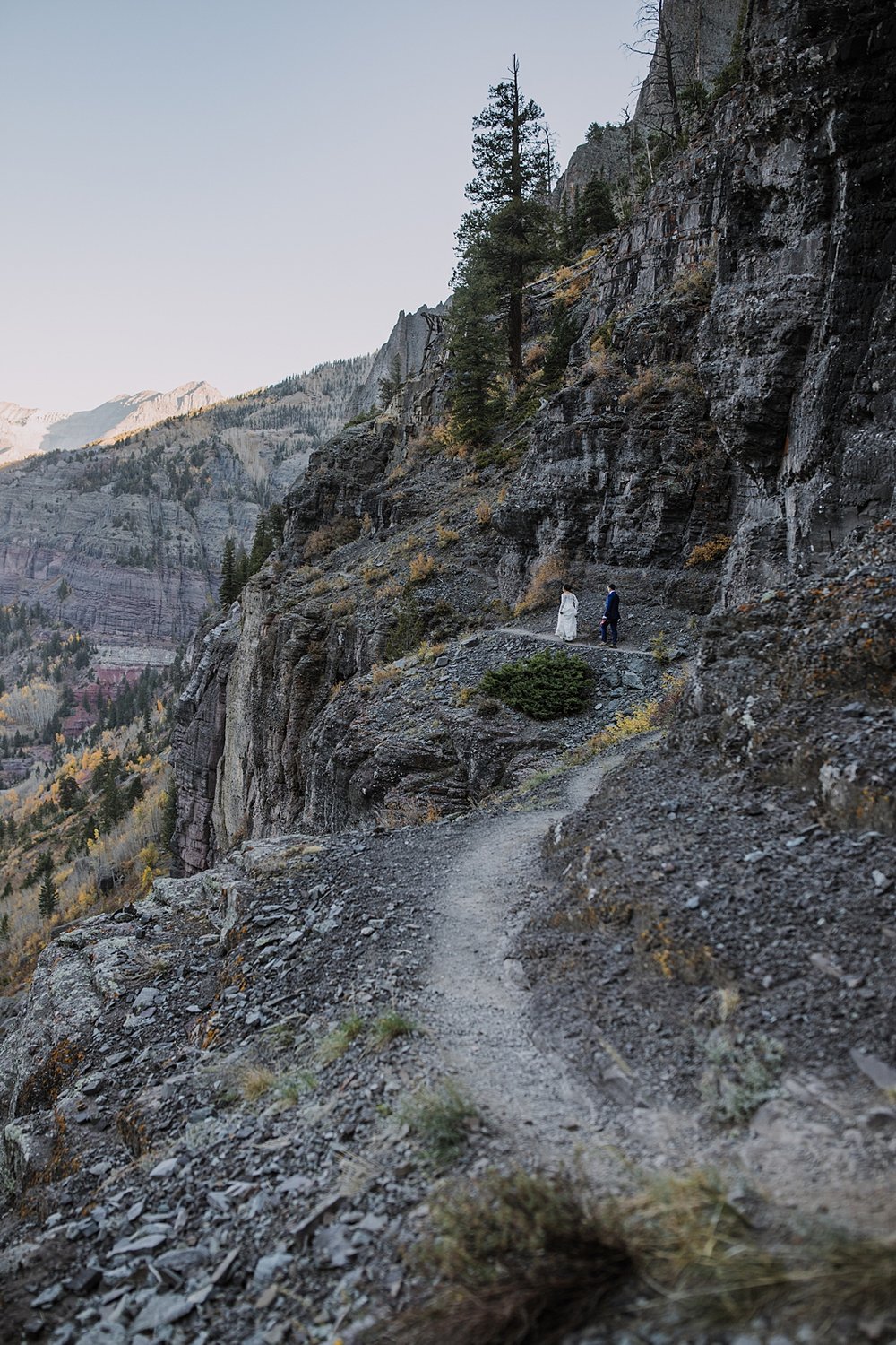 telluride via ferrata in a wedding dress, bride and groom eloping on a cliff edge, high alpine mountaineering elopement, high alpine elopement, southern colorado hiking elopement, climbing couple