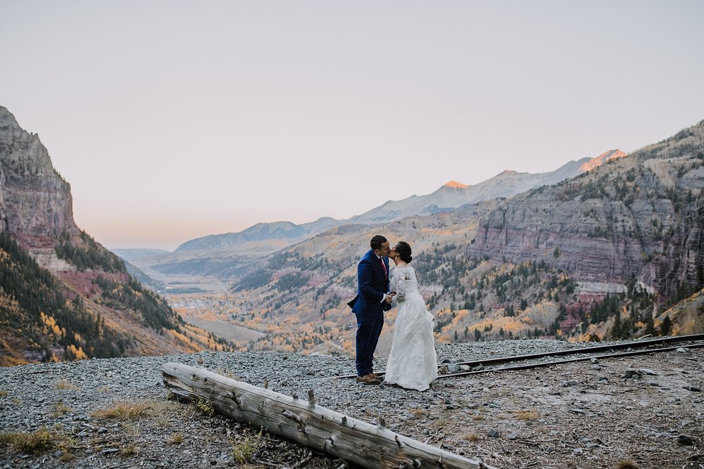 bride and groom kiss, cliffside climbing elopement, sunrise mountain alpineglow, elopement alpine glow, san juan mountains, hiking elopement, black bear pass 4x4 ohv road 