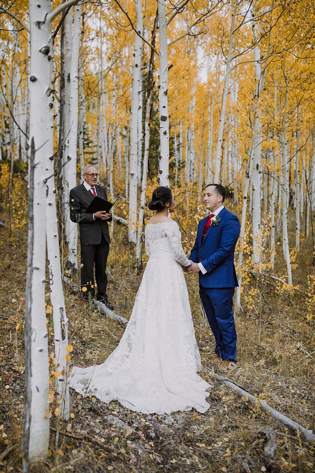 bride and groom exchange rings, elopement in an aspen grove, hiking through an aspen grove, southern colorado mountain elopement, southern colorado waterfall elopement, aspen leaf elopement