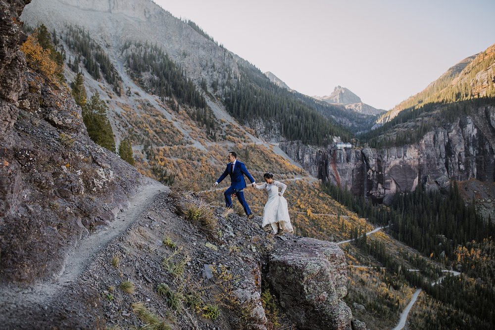 bride and groom hiking in the san juan mountains, cliffside elopement, mountain climbing elopement, colorado climbing elopement, southern colorado elopement, telluride elopement