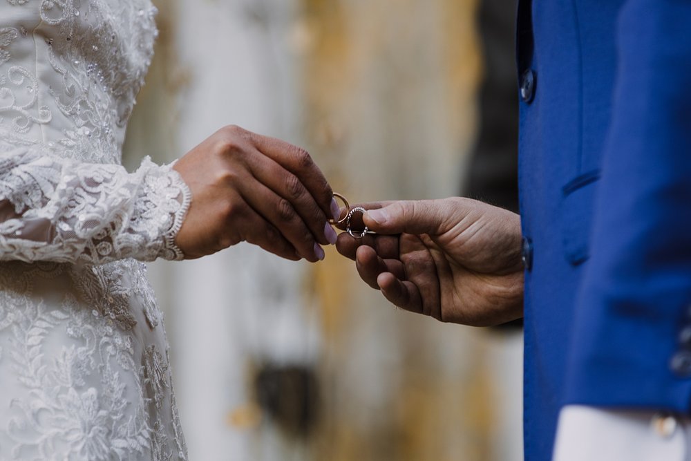 bride and groom exchange rings, elopement in an aspen grove, hiking through an aspen grove, southern colorado mountain elopement, southern colorado waterfall elopement, aspen leaf elopement