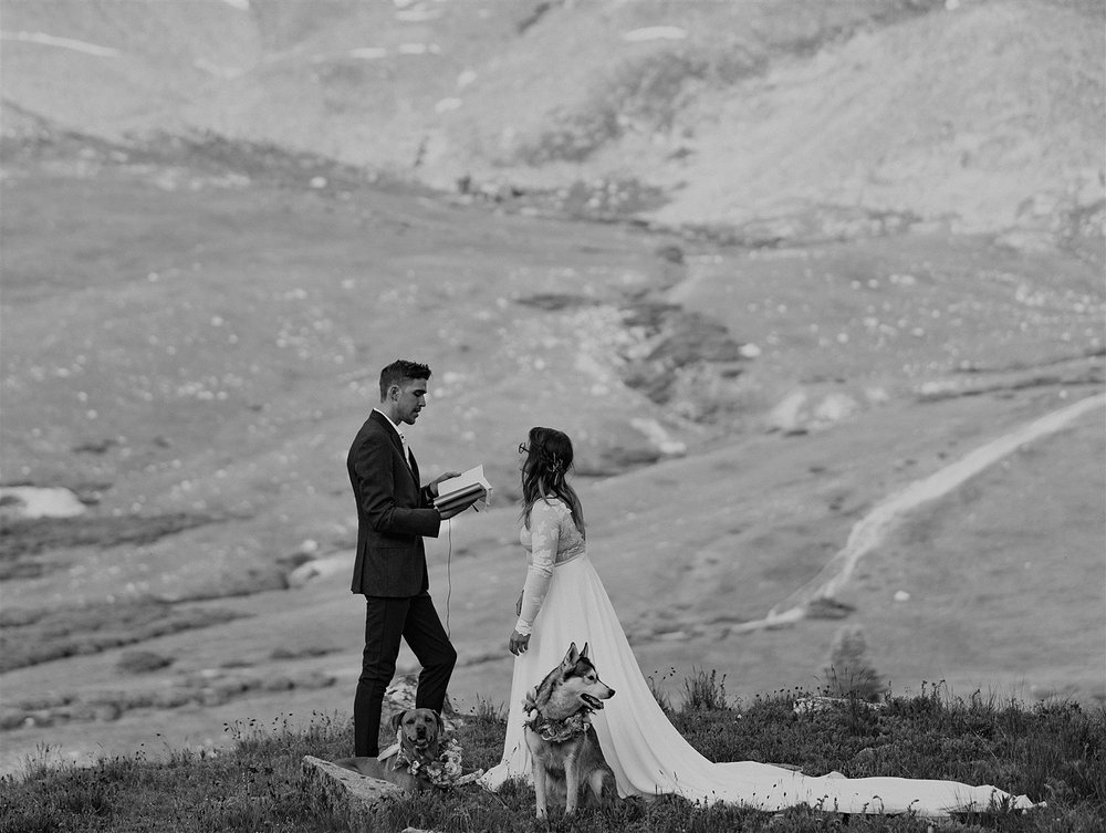 groom reading personal vows, elopement mountain ceremony, mayflower gulch hiking elopement, colorado mining camp elopement, colorado summer wildflower elopement