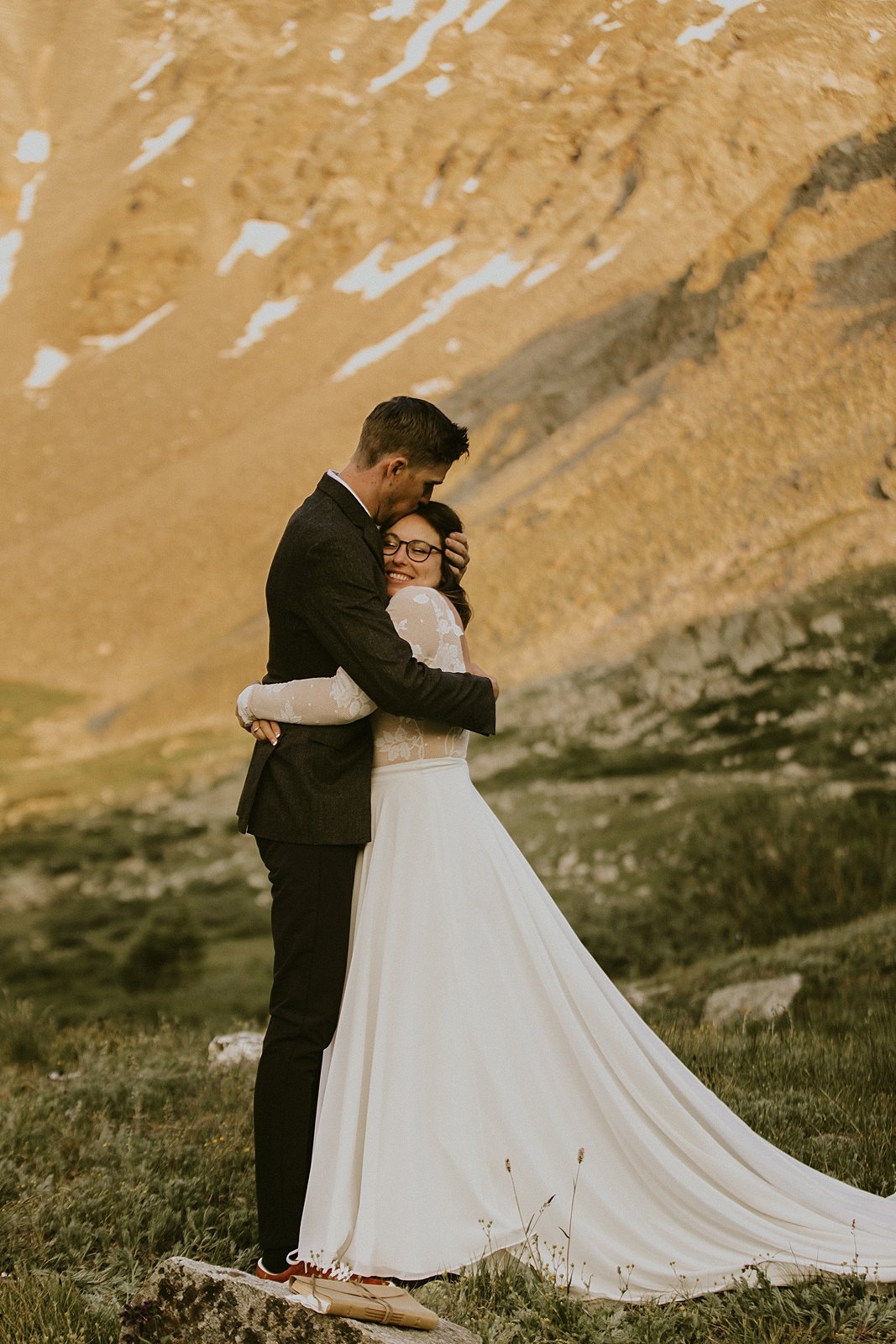 bride and groom hugging, elopement mountain ceremony, mayflower gulch elopement, colorado mining camp elopement, colorado summer wildflower elopement, rugged mountain elopement