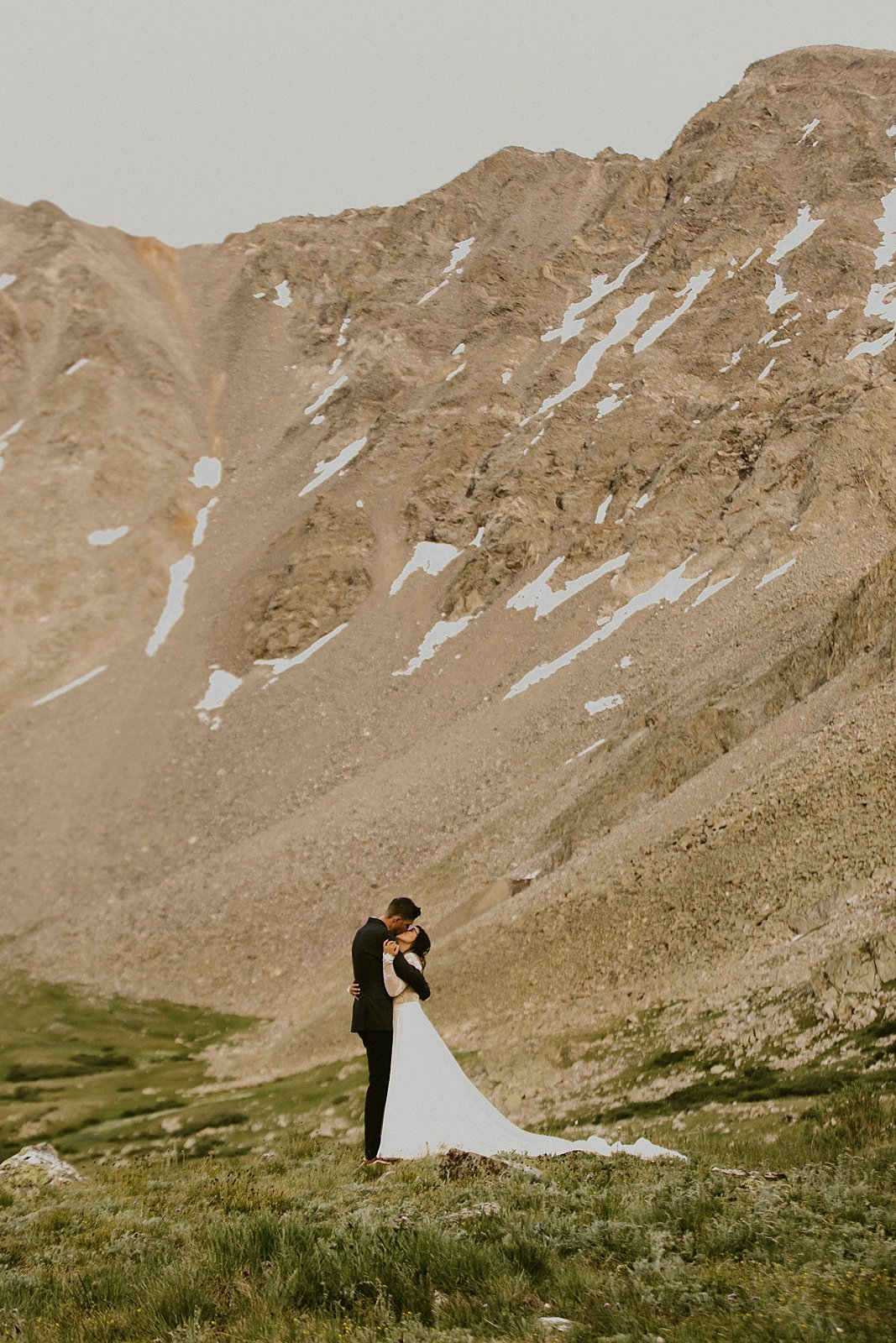 bride and groom kissing, elopement mountain ceremony, mayflower gulch elopement, colorado mining camp elopement, colorado summer wildflower elopement, rugged mountain elopement