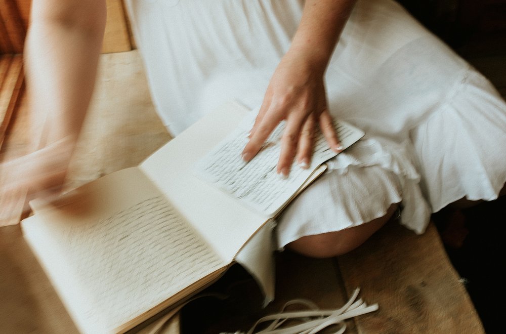 bride writing personal wedding vows, getting ready at studio 508, city on a hill coffee shop elopement, leadville colorado elopement, lake county elopement, colorado mountain elopement