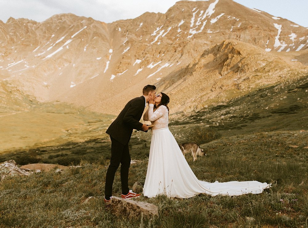 bride and groom kissing, elopement mountain ceremony, mayflower gulch elopement, colorado mining camp elopement, colorado summer wildflower elopement, rugged mountain elopement