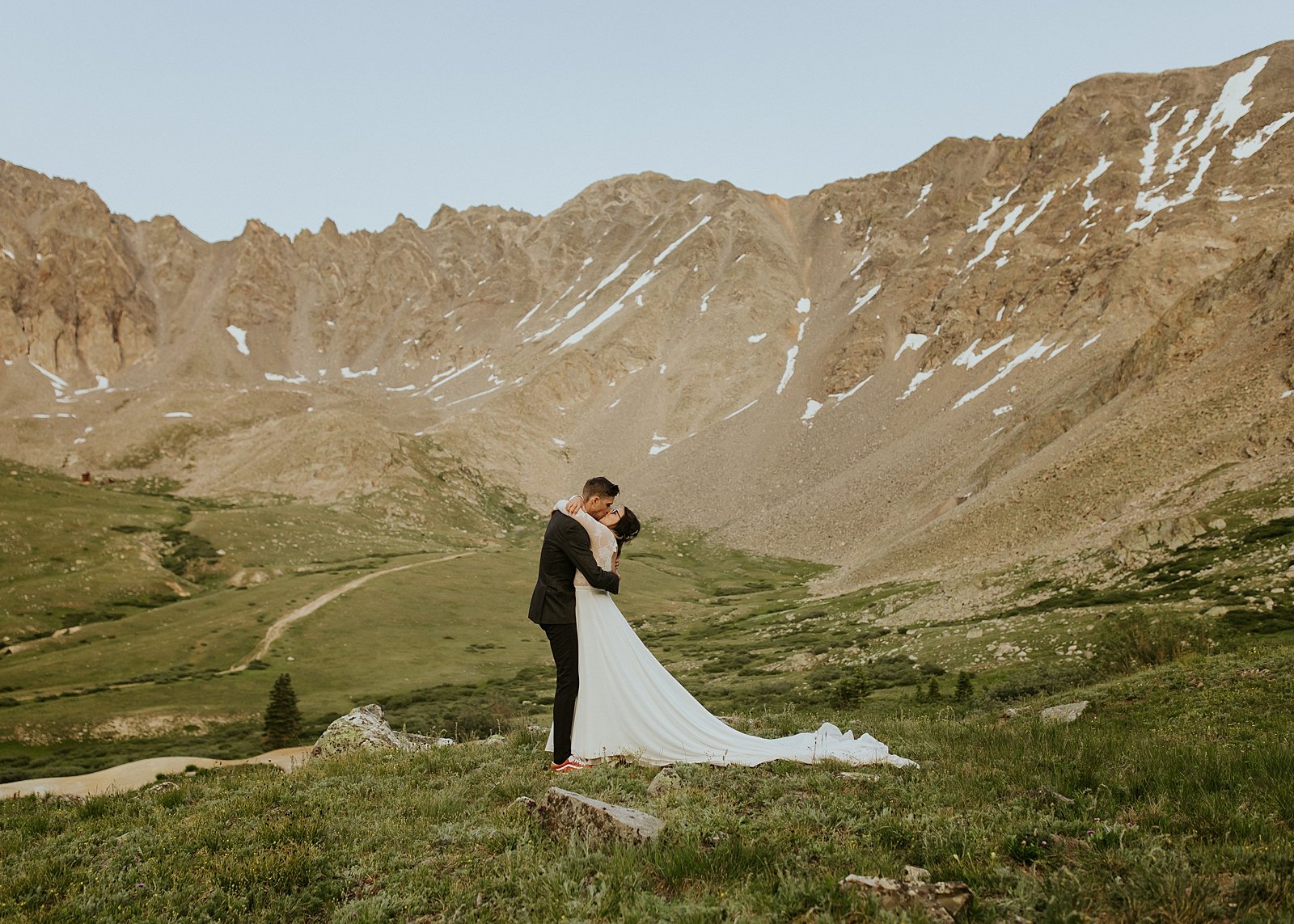 bride and groom in mountain scape, lake county colorado elopement, colorado adventure elopement, rocky mountain summer wildflowers, valley of wildflowers elopement, mountain meadow elopement