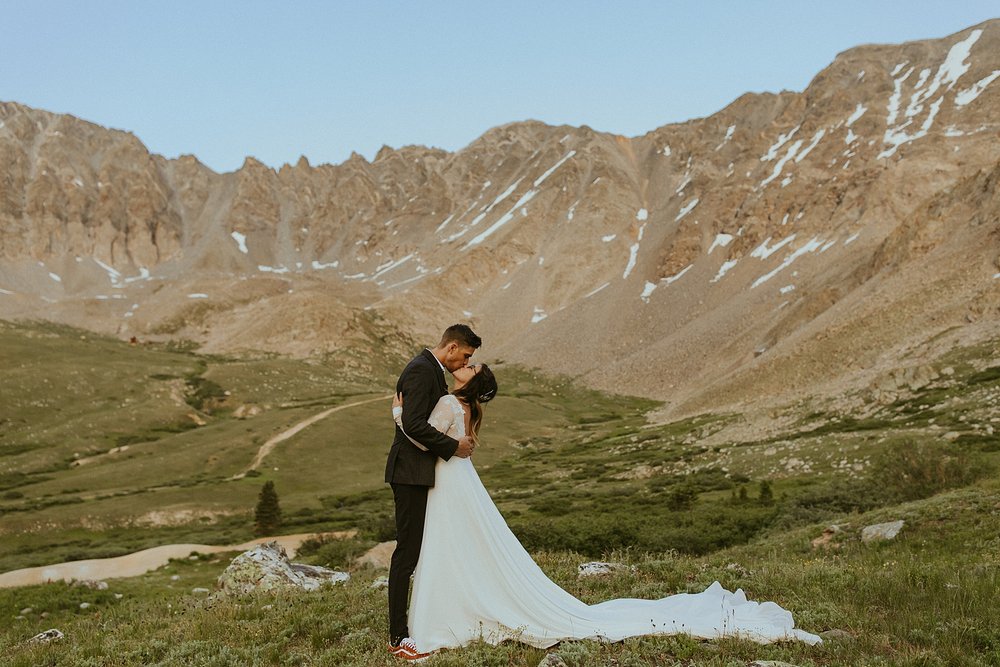 bride and groom in mountain scape, lake county colorado elopement, colorado adventure elopement, rocky mountain summer wildflowers, valley of wildflowers elopement, alpine glow sunset elopement