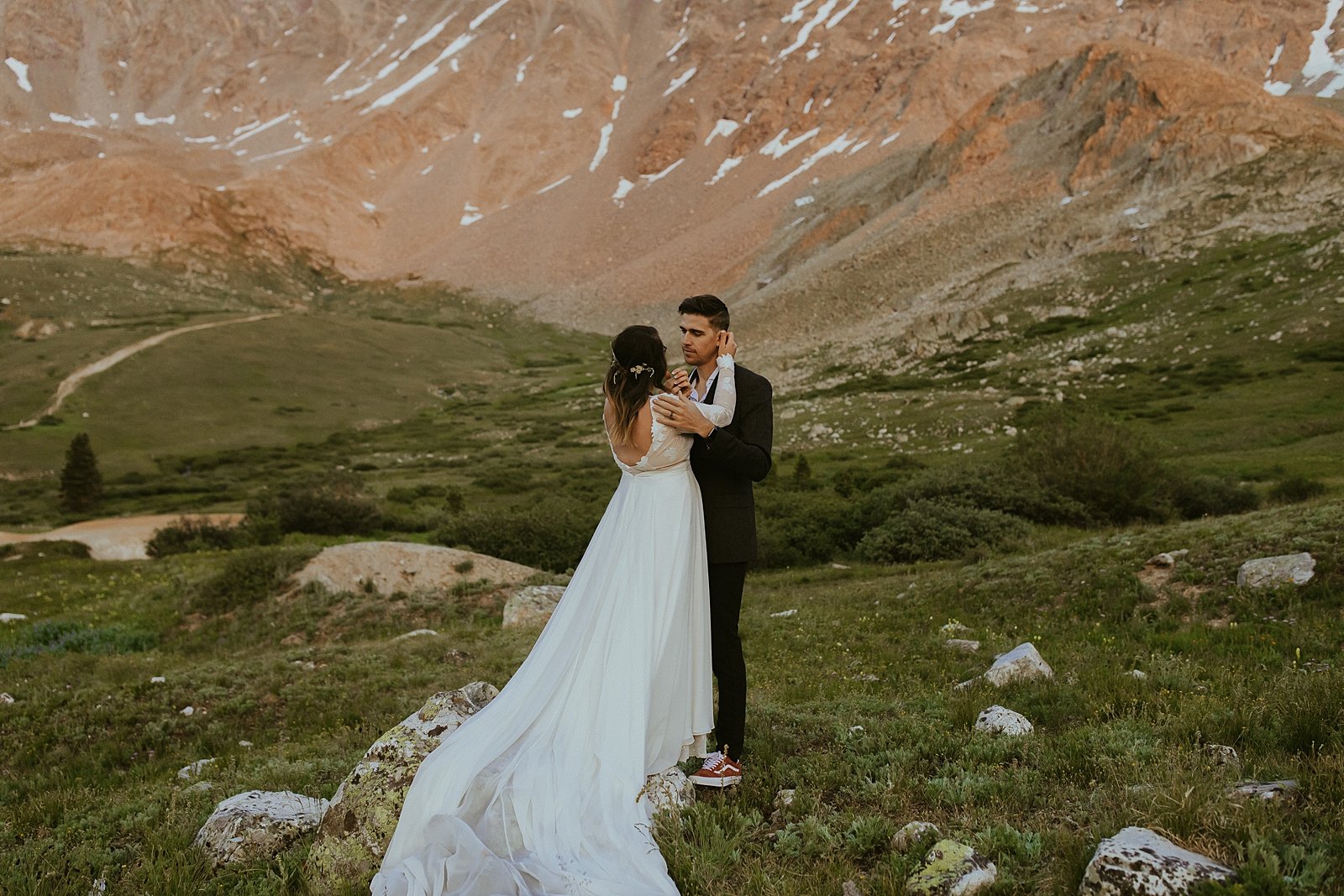 bride and groom in mountain scape, lake county colorado elopement, colorado adventure elopement, rocky mountain summer wildflowers, valley of wildflowers elopement, alpine glow sunset elopement