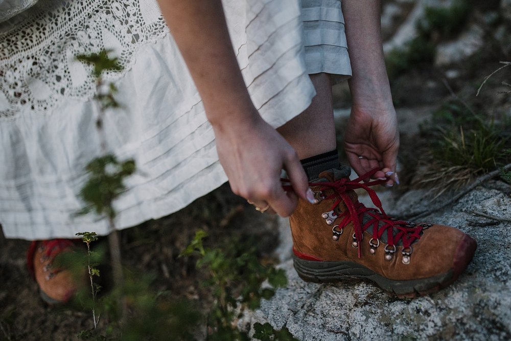 bride tying laces of hiking boots, shoshoni peak elopement, lake isabelle elopement, pawnee pass elopement, hiking long lake and lake isabelle, brainard lake elopement