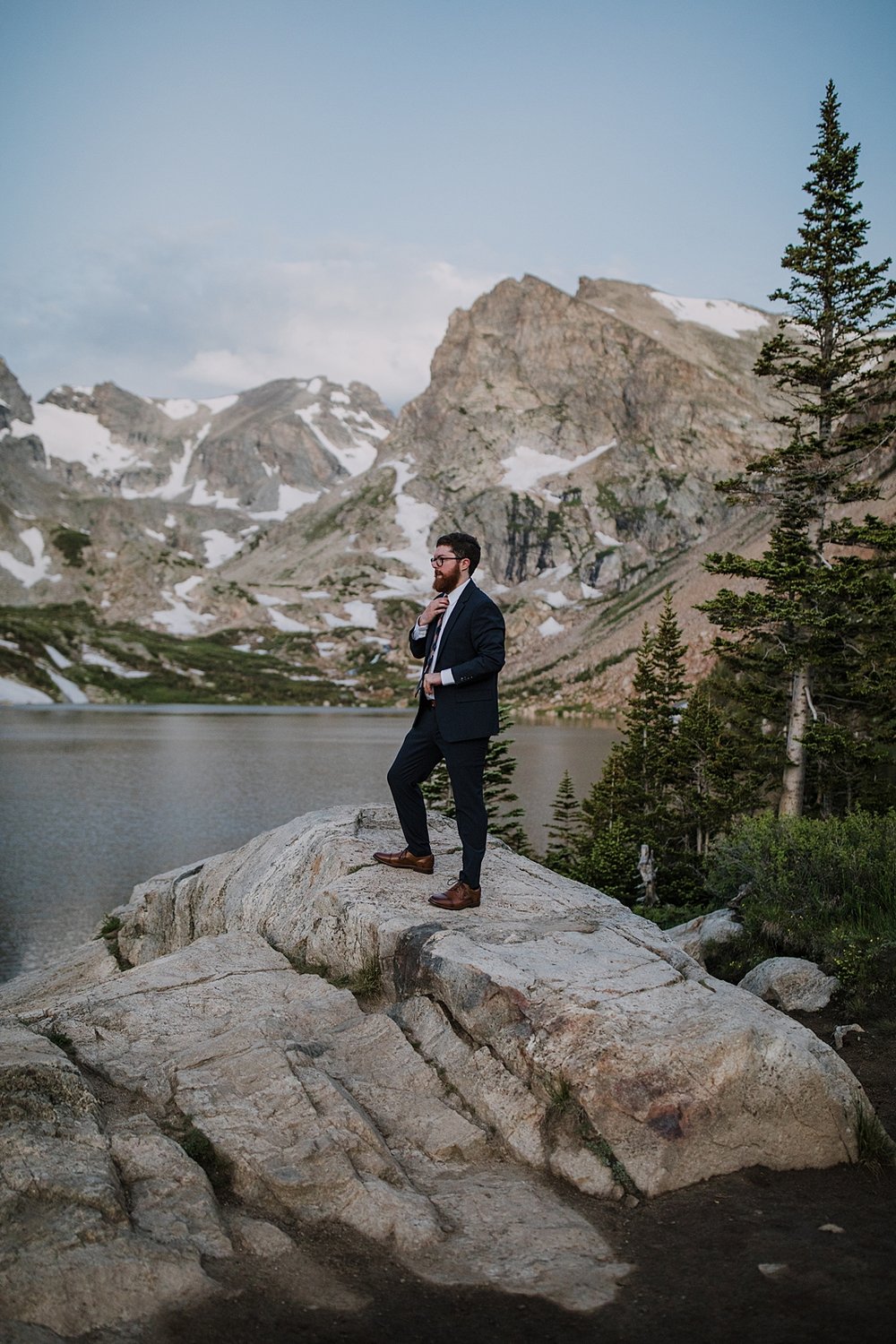 groom buttoning cuff links, lake isabelle at dawn, continental divide elopement, adventurous mountain elopement, indian peaks wilderness elopement, brainard lake recreation area elopement