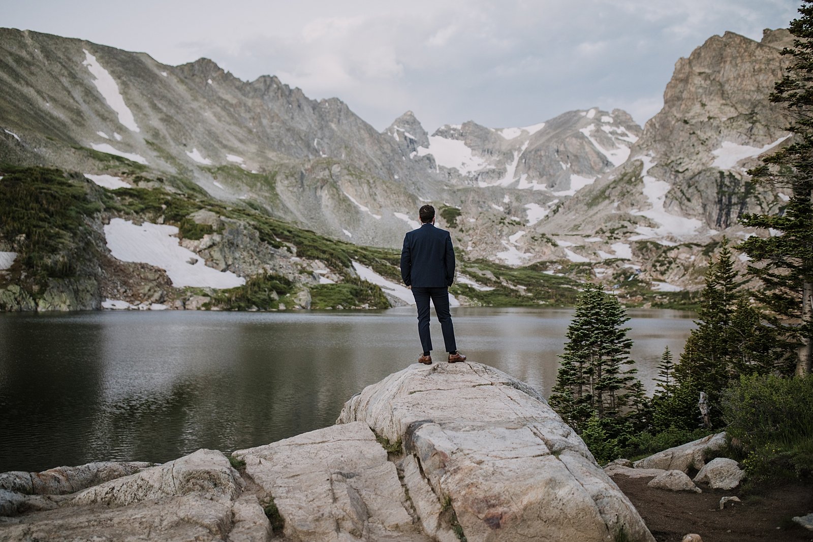 groom awaiting his bride, bride and groom elopement first look, indian peaks wilderness, elopement at lake isabelle, backcountry trekking elopement, glacier valley elopement