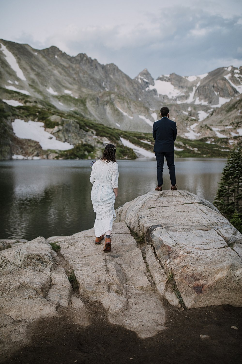 bride hiking trail to groom, bride and groom elopement first look, indian peaks wilderness, elopement at lake isabelle, backcountry trekking elopement, glacier valley elopement