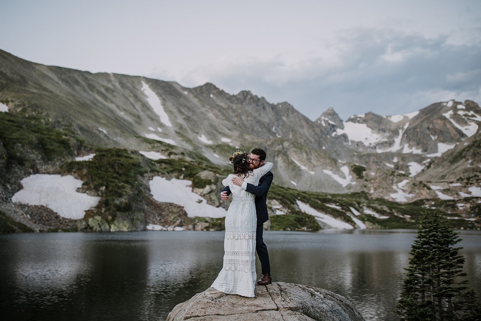 bride and groom elopement first look, bride and groom standing on lake shore, indian peaks wilderness, elopement at lake isabelle, backcountry trekking elopement, glacier valley elopement