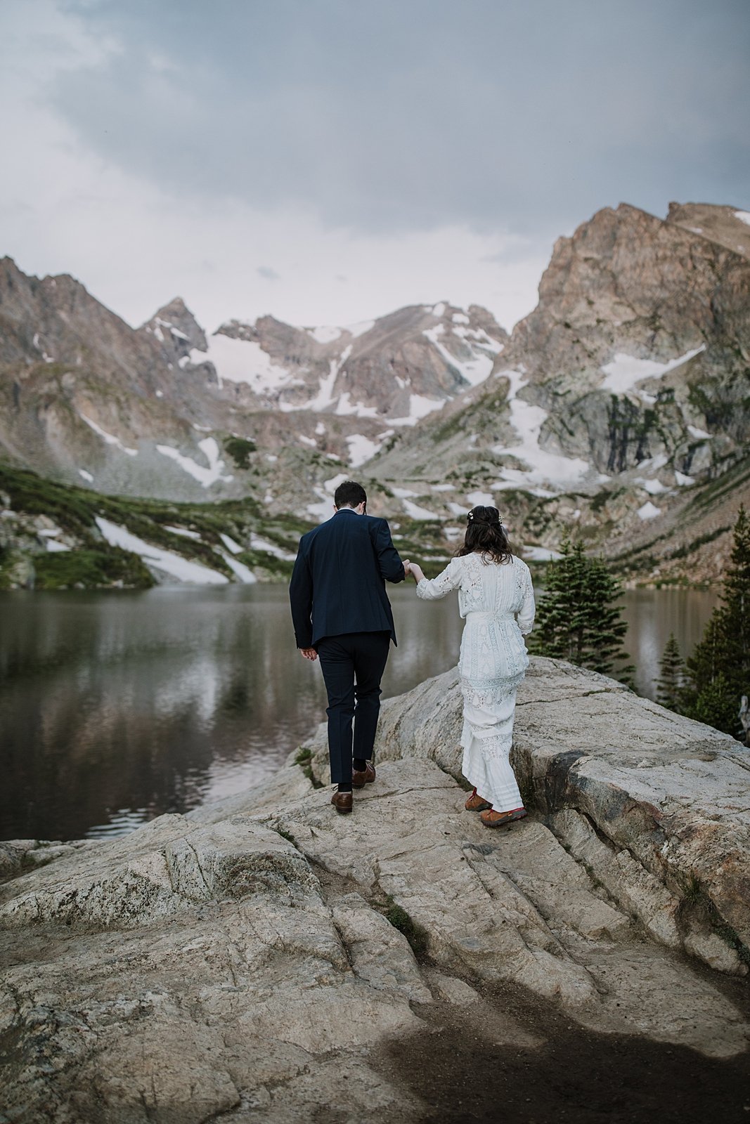 bride and groom hiking, lake shore elopement ceremony, ward colorado elopement, estes park elopement, nederland elopement, alpine lake elopement