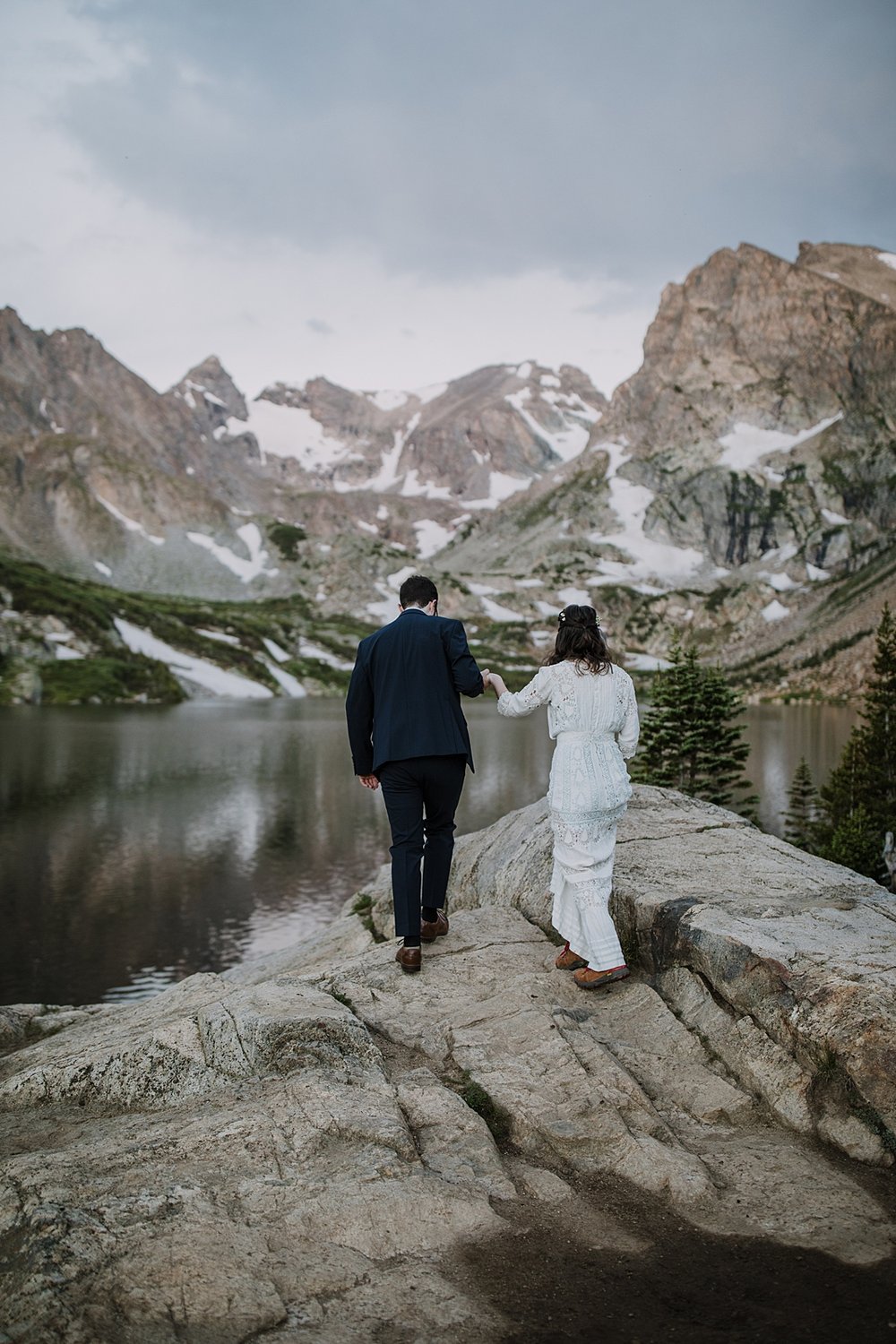 bride and groom hiking, lake shore elopement ceremony, ward colorado elopement, estes park elopement, nederland elopement, alpine lake elopement