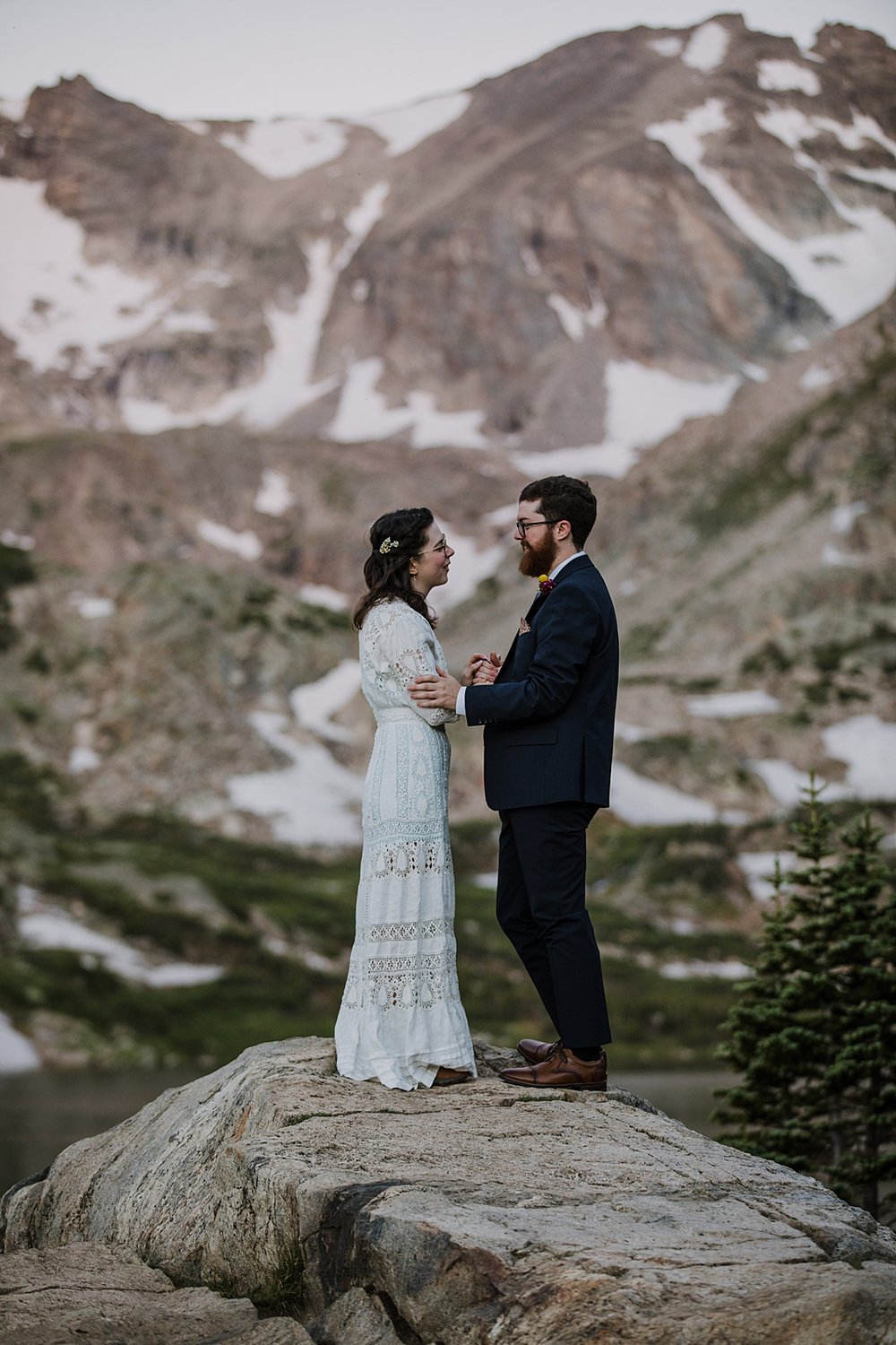 bride and groom watching sunrise, lake shore elopement ceremony, ward colorado elopement, estes park elopement, nederland elopement, alpine lake elopement