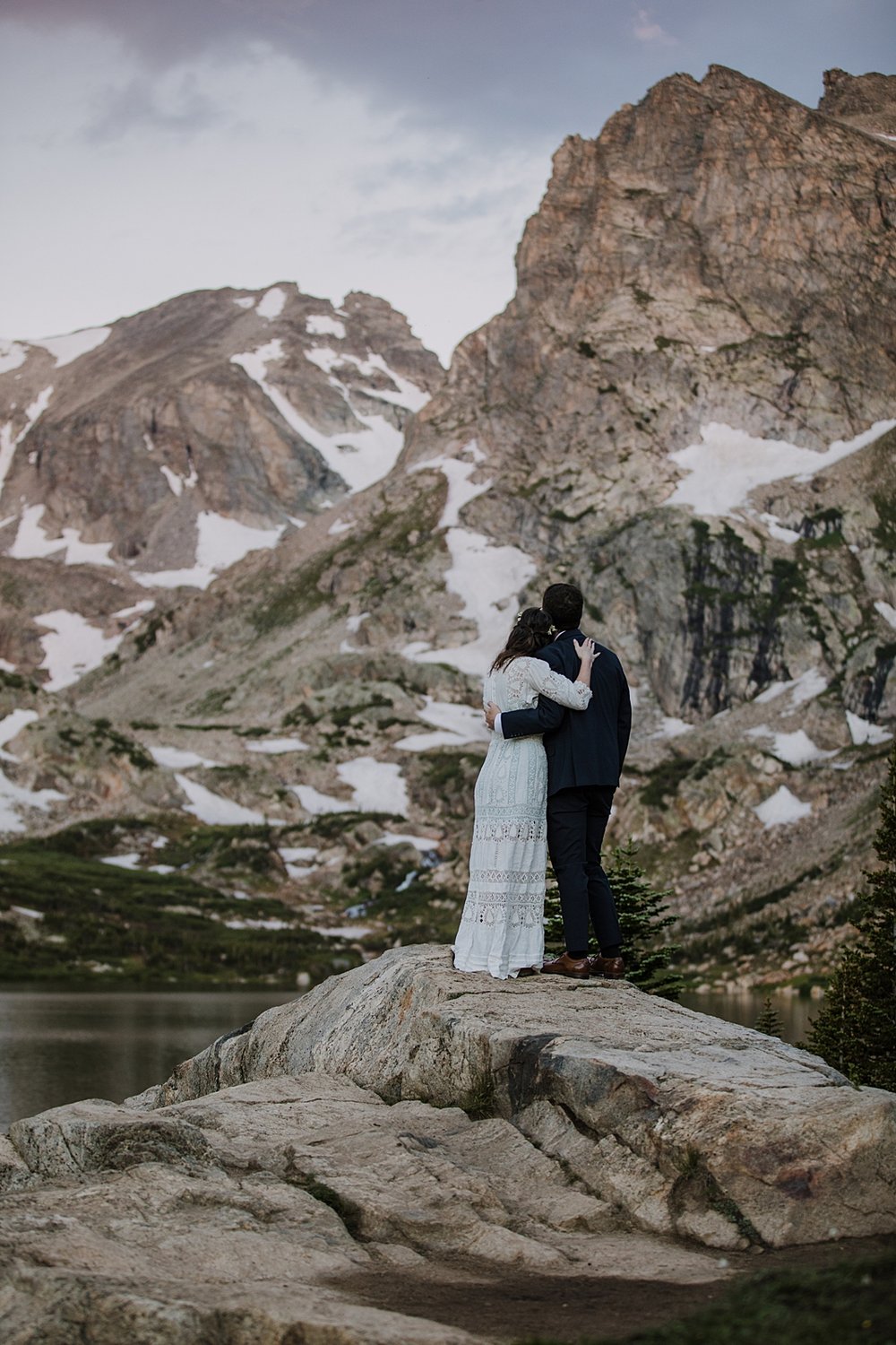 bride and groom watching sunrise, lake shore elopement ceremony, ward colorado elopement, estes park elopement, nederland elopement, alpine lake elopement