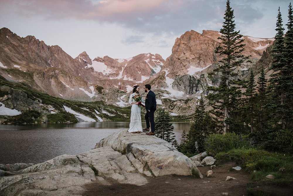 couple hugging, sunrise on shoshoni peak, alpine glow in the indian peaks wilderness, alpine lake elopement ceremony, colorado front range sunrise