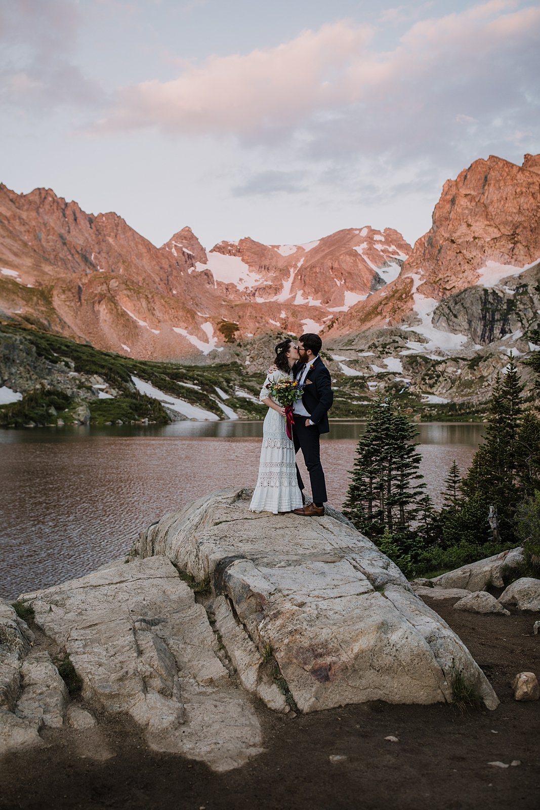 couple kissing at sunrise, sunrise on shoshoni peak, alpine glow in the indian peaks wilderness, alpine lake elopement ceremony, colorado front range sunrise