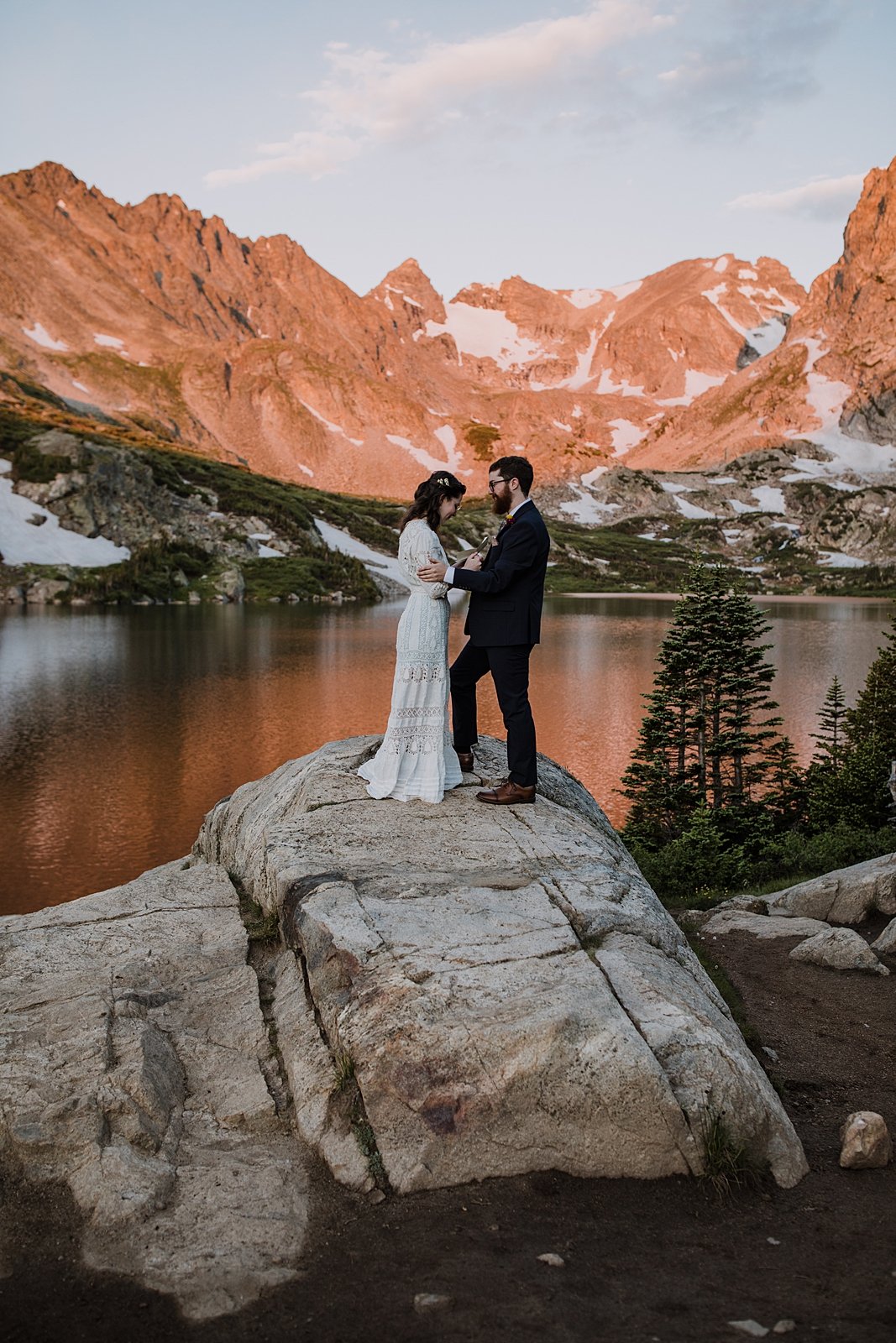 couple saying their wedding vows, shoshoni peak alpenglow, sunrise over lake isabelle, mountainside elopement ceremony, front range alpenglow, pink mountains