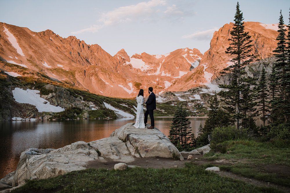 couple eloping in the mountains, self solemnizing in colorado, self solemnizing ceremony, hiking elopement ceremony, continental divide sunrise, pink mountains