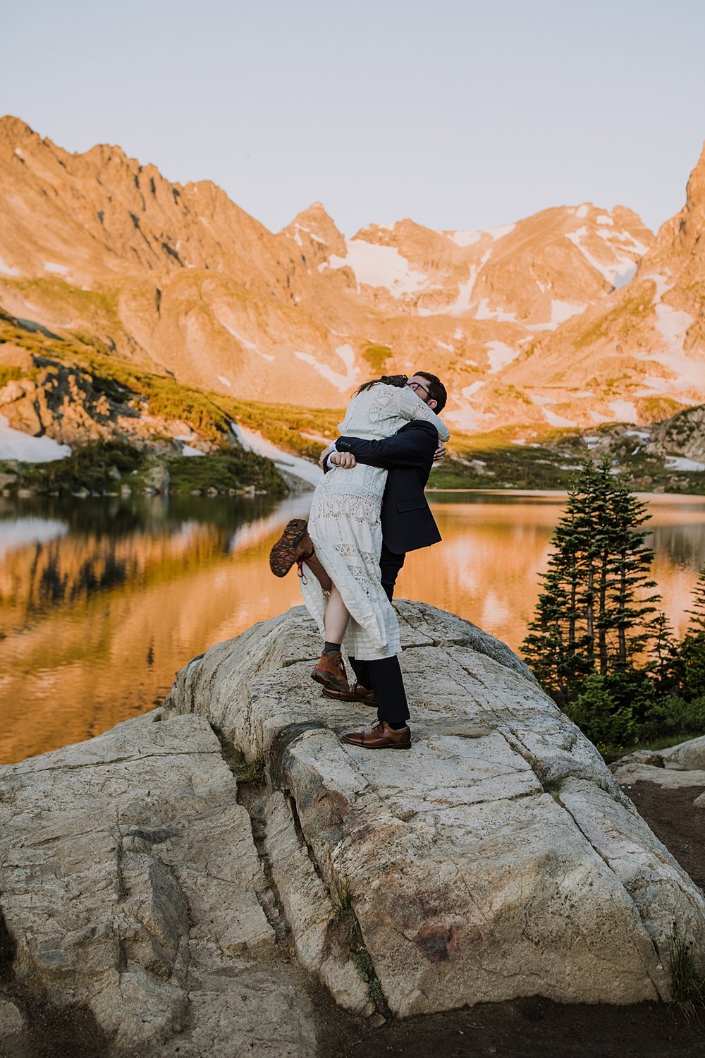 bride jumping in grooms arms, groom swinging bride around, antique edwardian wedding dress, century old wedding dress, alpine lake adventure elopement, sealing the deal