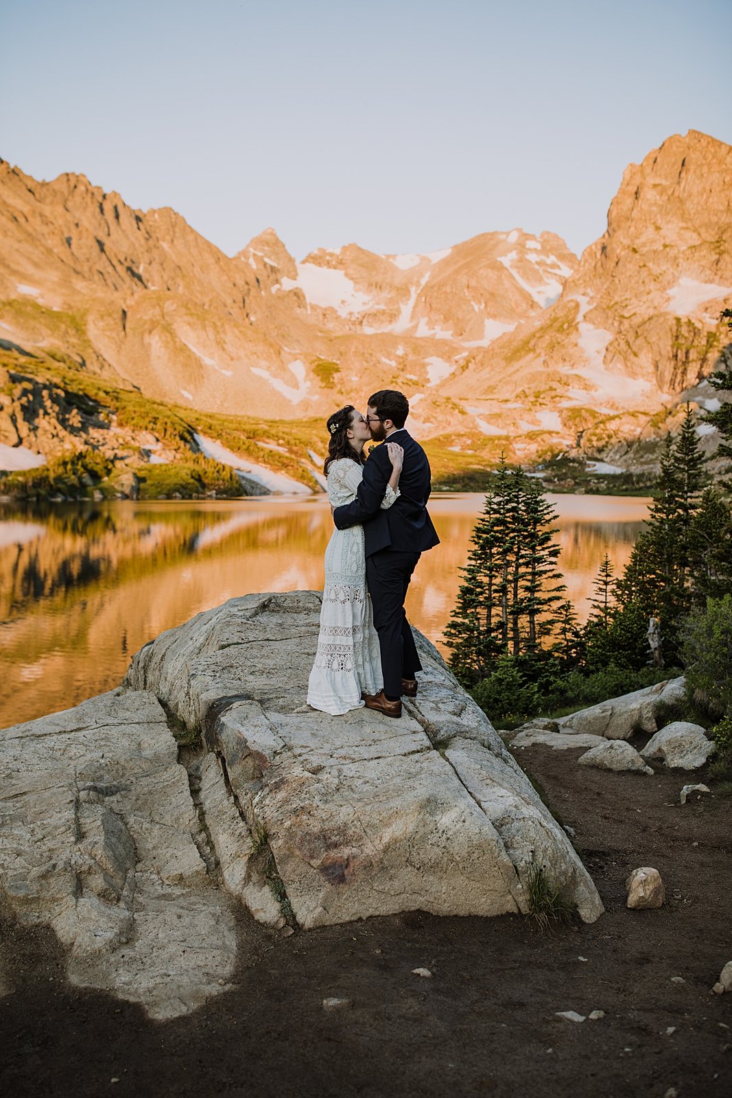 bride and groom kissing, couple cuddling, hand crotched lace wedding dress, 100 year old wedding dress, sunrise hiking in the rocky mountains, mitchell lake parking