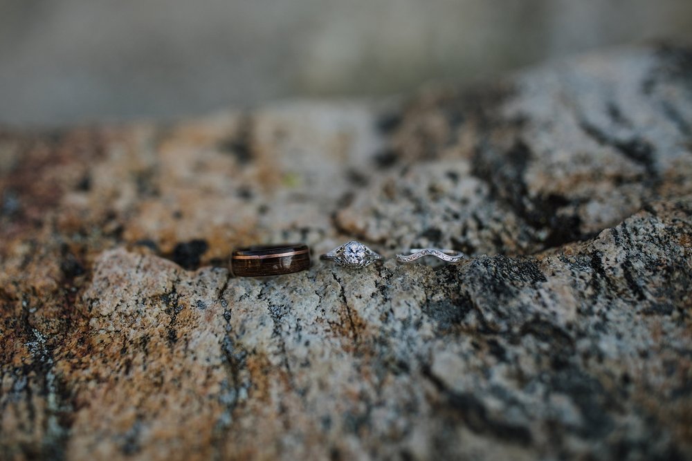 wedding rings on glacier rock, bride and grooms wedding rings, wedding details outside, glacier elopement, glacier run off, sunrise on glacier valley, mountain granite, wedding rings in the mountains