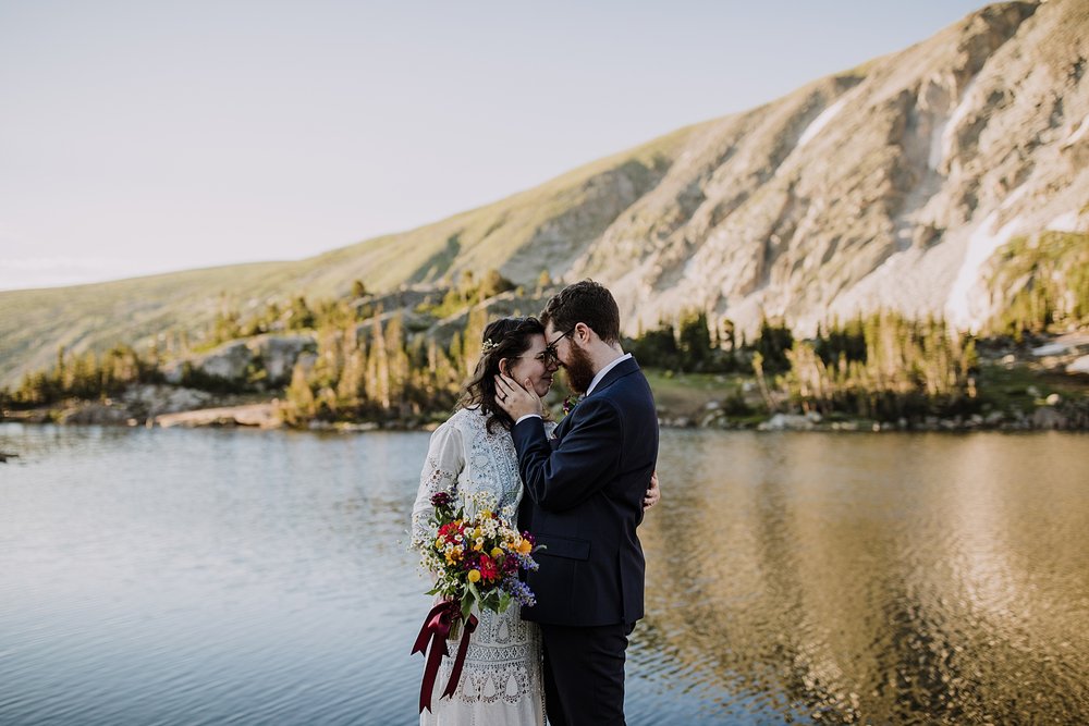 couple cuddling, eloping above tree line, post vow celebration, post vow exploring, honeymoon roadtrip, western states roadtrip, budget wedding dress, budget elopement, high alpine trail hiking