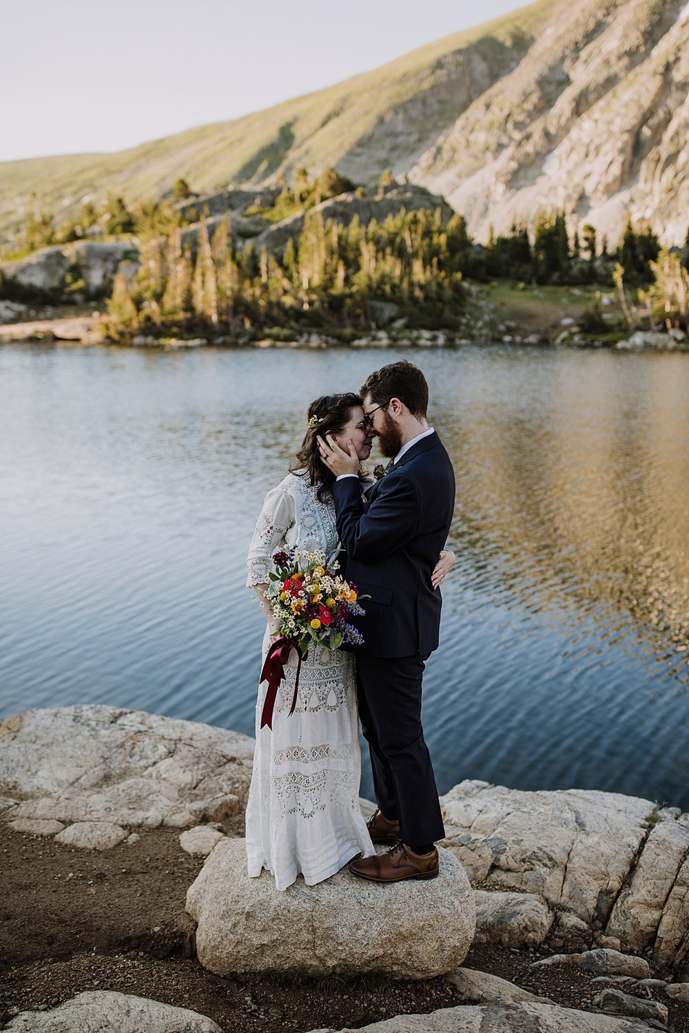 couple cuddling, eloping above tree line, post vow celebration, post vow exploring, honeymoon roadtrip, western states roadtrip, budget wedding dress, budget elopement, high alpine trail hiking