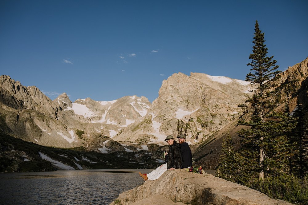 couple sitting on rock overlooking alpine lake, lake isabelle view, hiking lake isabelle glacier trail, pawnee pass trail, shoshoni peak