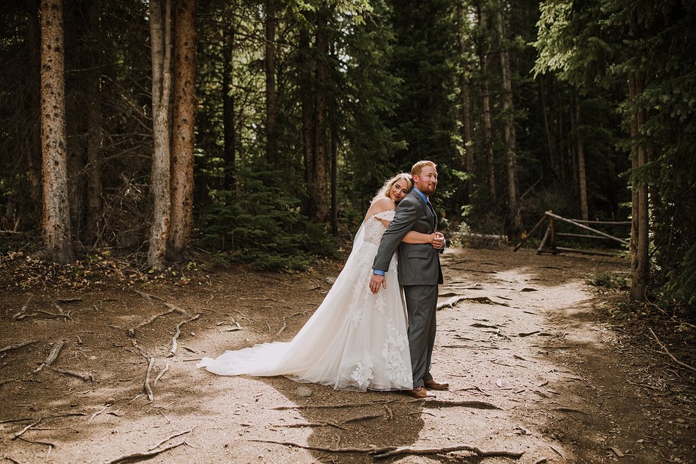 bride hugging groom, breckenridge mountain wedding, breckenridge nordic center wedding, breckenridge hiking wedding, breckridge trail wedding, summit county colorado wedding, peak 8 wedding