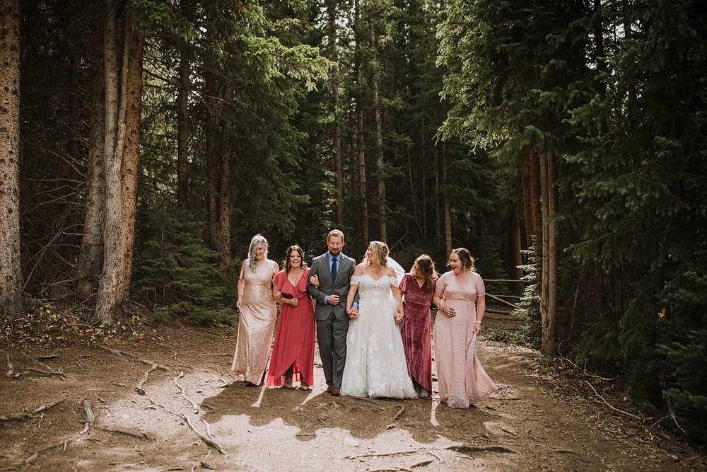 bridal party walking together, breckenridge nordic center wedding, breckenridge ski mountain wedding, carter park pavilion wedding, summit county colorado wedding, fall wedding in breckenridge