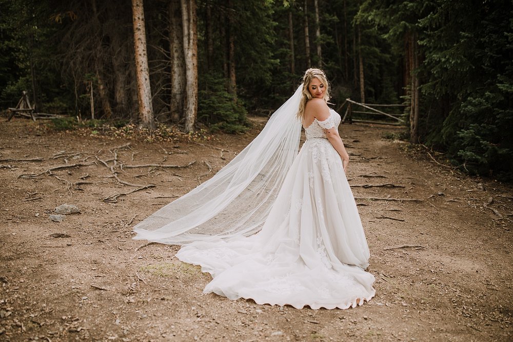 bride in a pine tree forest, breckenridge nordic center wedding, breckenridge ski mountain wedding, carter park pavilion wedding, summit county colorado wedding, fall wedding in breckenridge