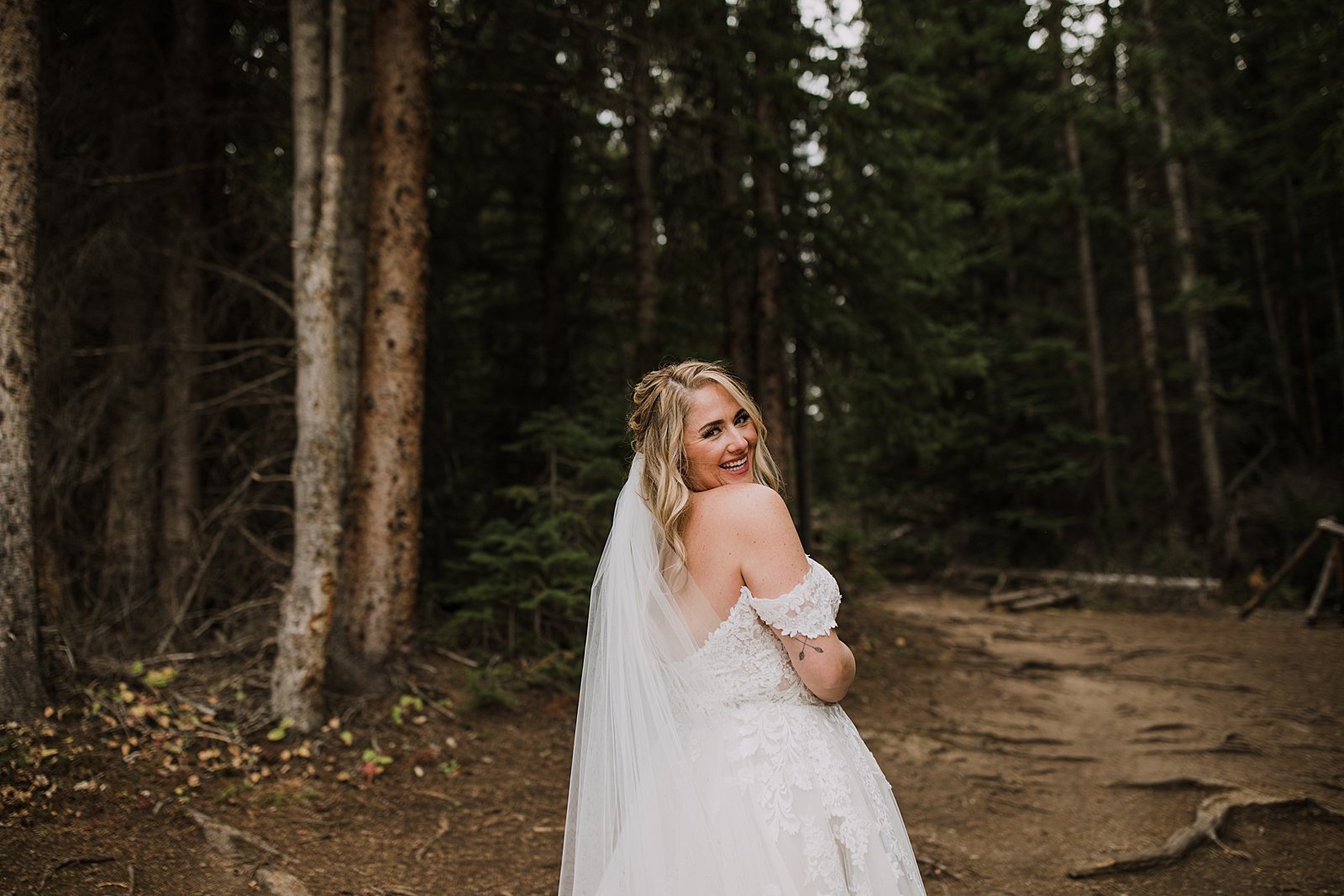 bride in a pine tree forest, breckenridge nordic center wedding, breckenridge ski mountain wedding, carter park pavilion wedding, summit county colorado wedding, fall wedding in breckenridge