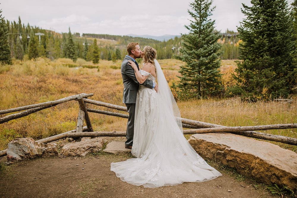 groom kissing bride, breckenridge forest wedding, colorado wooded wedding, breckenridge nordic center hiking trails, breckenridge fall hiking elopement, breckenridge wedding photographer