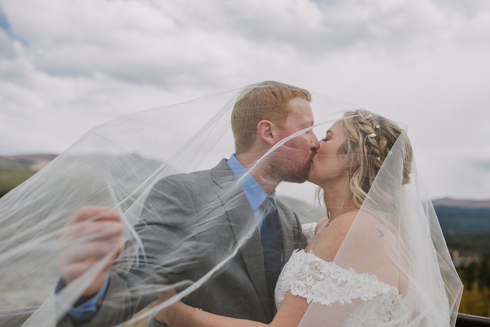 bride and groom kissing at breckenridge overlook, mt. baldy colorado wedding, baldy mountain wedding in breckenridge colorado, september wedding in colorado, breckenridge summer wedding