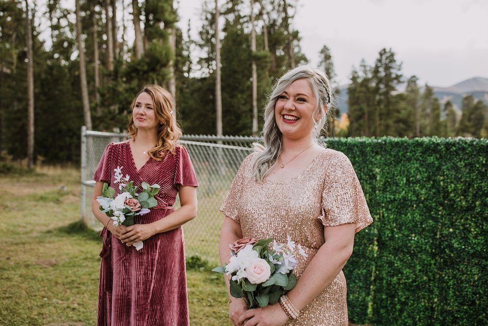 bridesmaids smiling, bride walking down the aisle, breckenridge colorado fall wedding, carter park pavilion fall wedding, intimate wedding reception at carter park pavilion in breckenridge